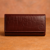 A Mehroon colored Crocodile Clutch