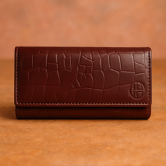 A Mehroon colored Crocodile Clutch